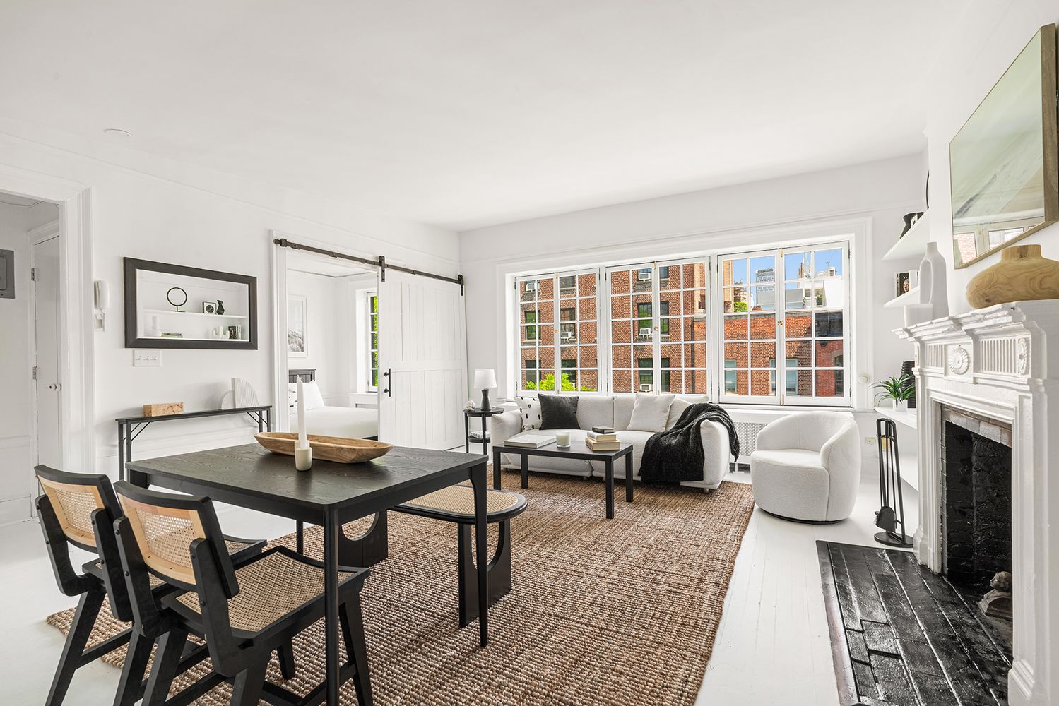 30-32 West 9th Street, Unit 5A Manhattan, NY 10011 - Photo 4 of 18 a living room with furniture and a fireplace