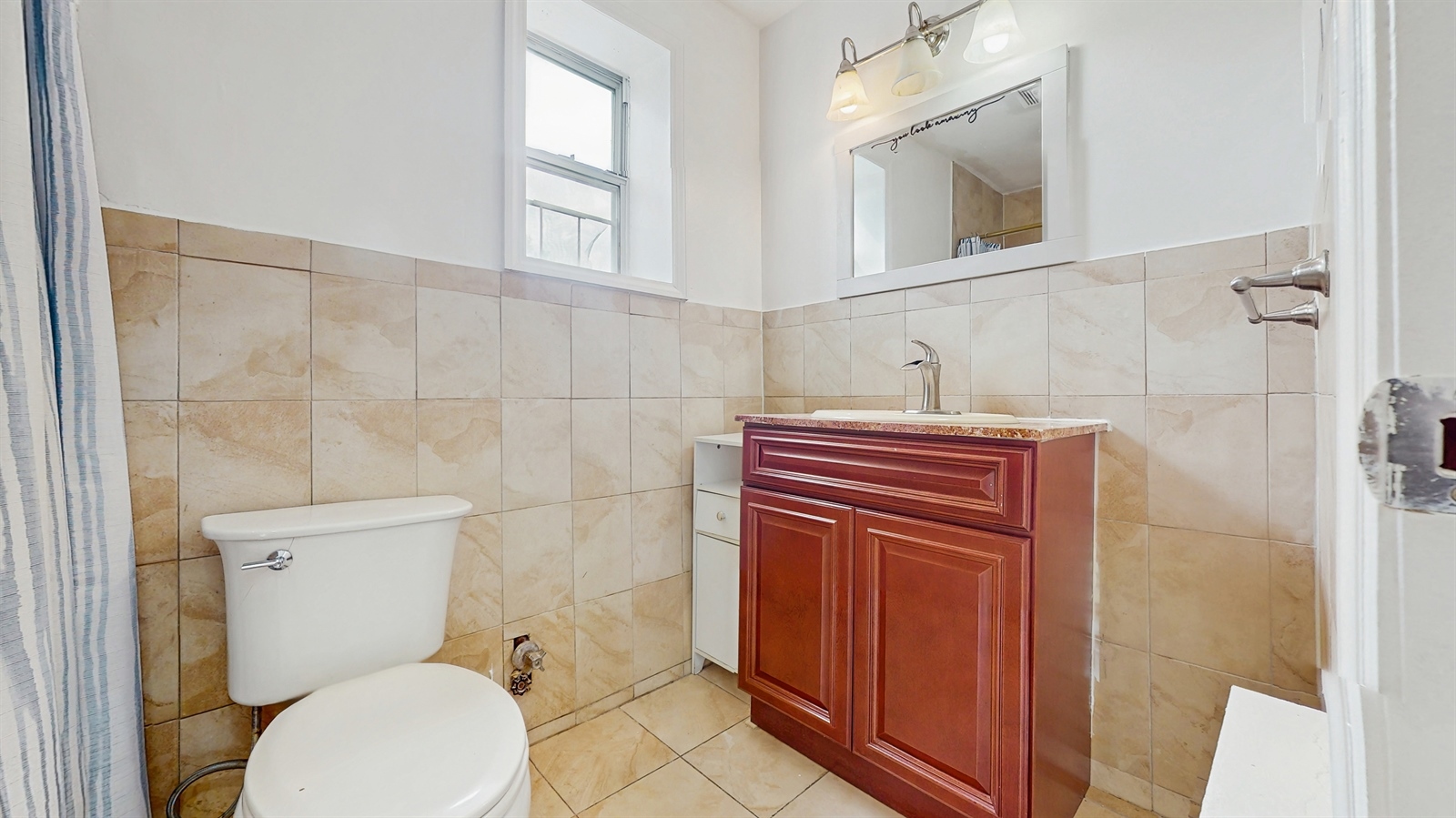 295 Conklin Avenue, Unit 3 Brooklyn, NY 11236 - Photo 13 of 15 a bathroom with a toilet a sink and mirror