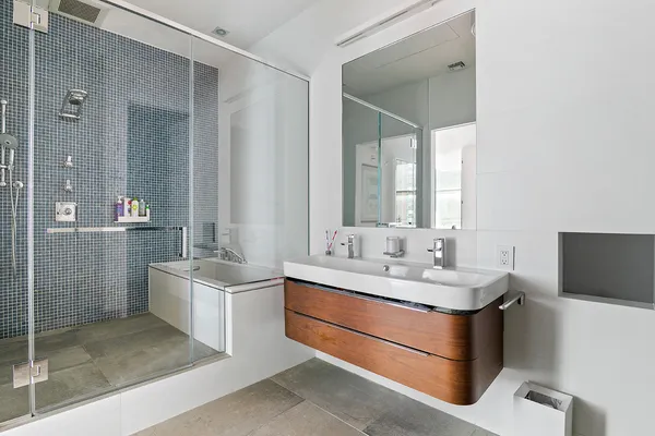 a bathroom with a double vanity sink toilet and shower