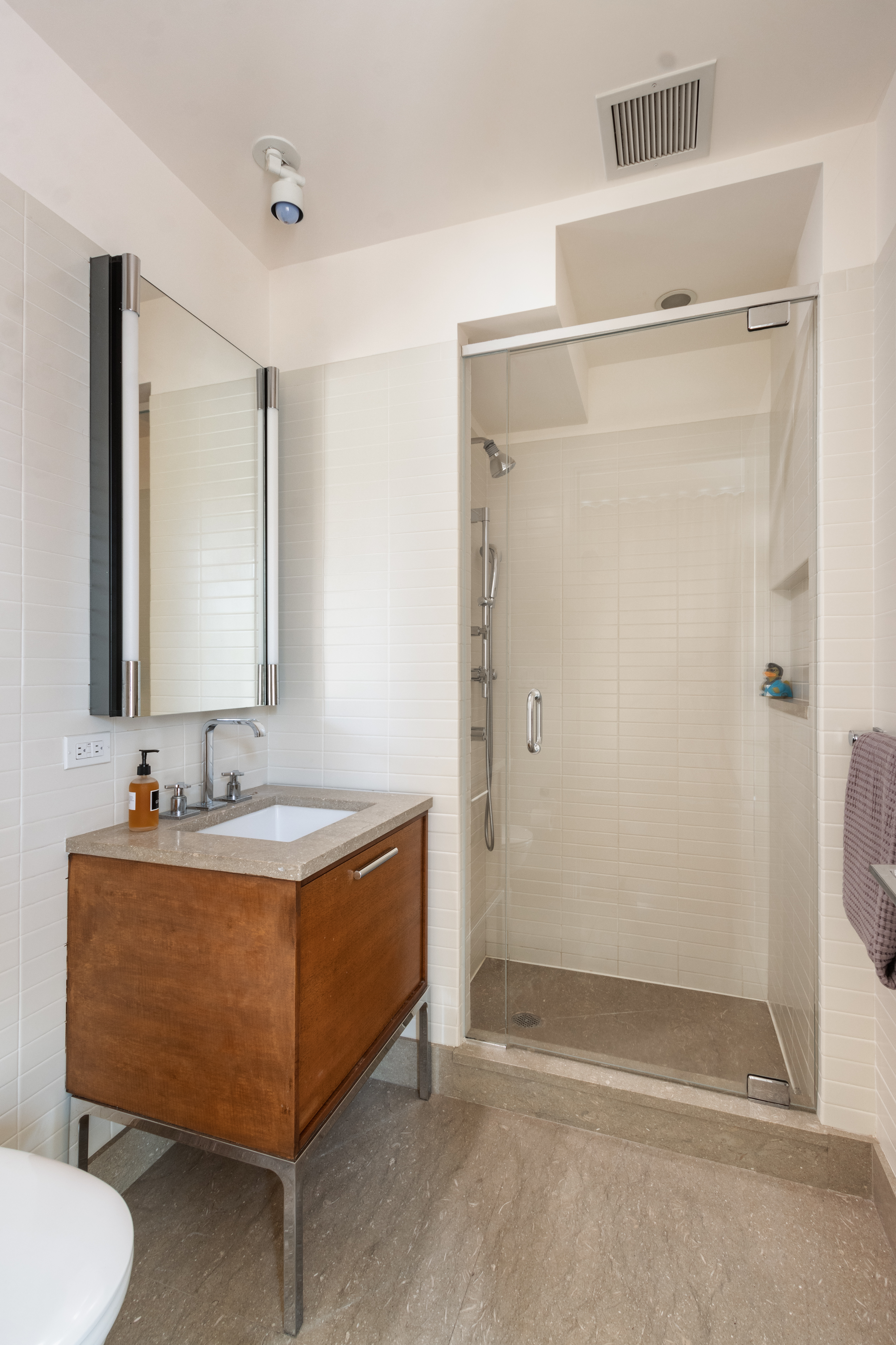 177 9th Avenue, Unit PHA Manhattan, NY 10011 - Photo 18 of 28 a bathroom with a sink and a mirror
