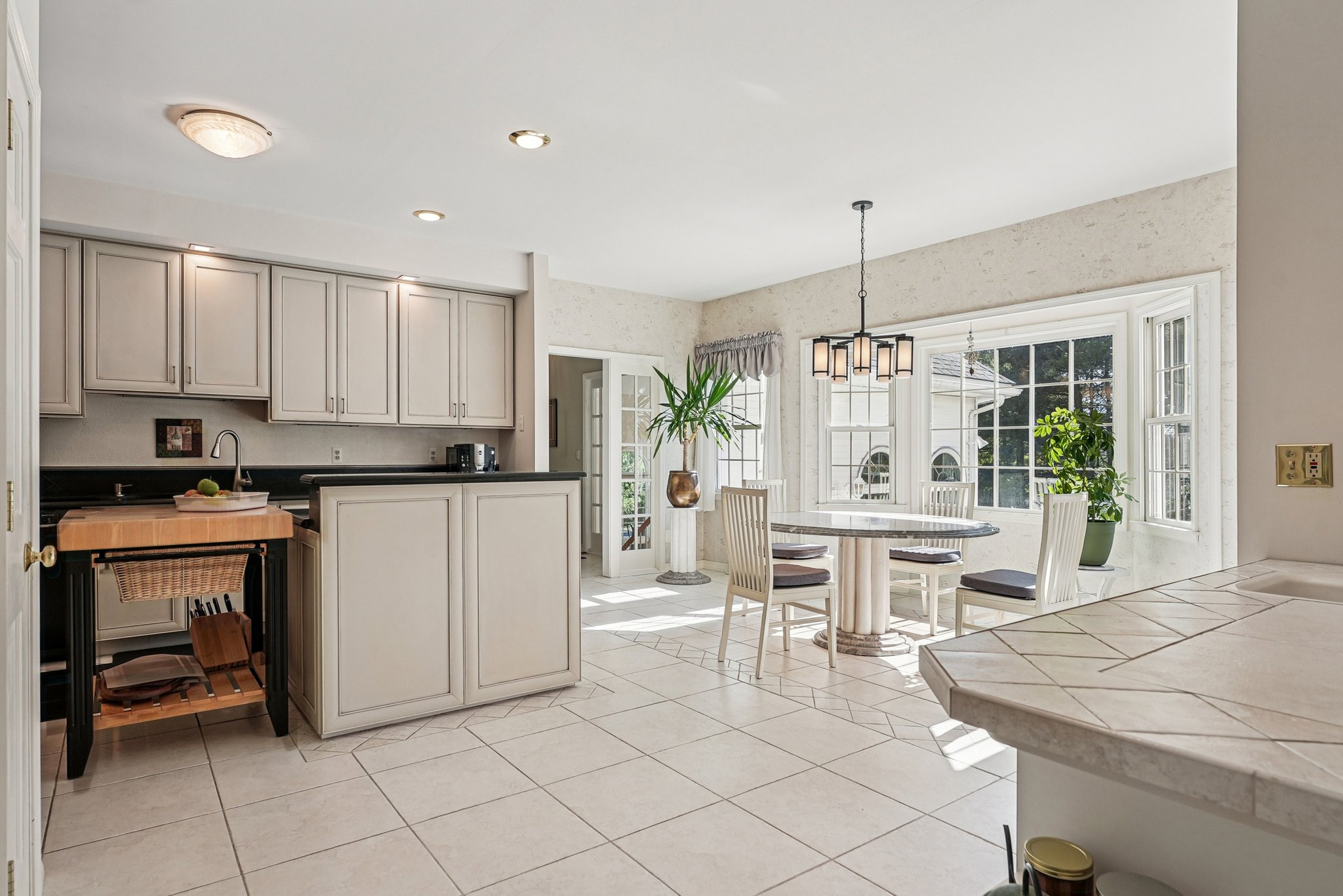 905 Kip Lane Neshanic Station, NJ 08853 - Photo 18 of 50 a kitchen with kitchen island granite countertop a table and chairs in it