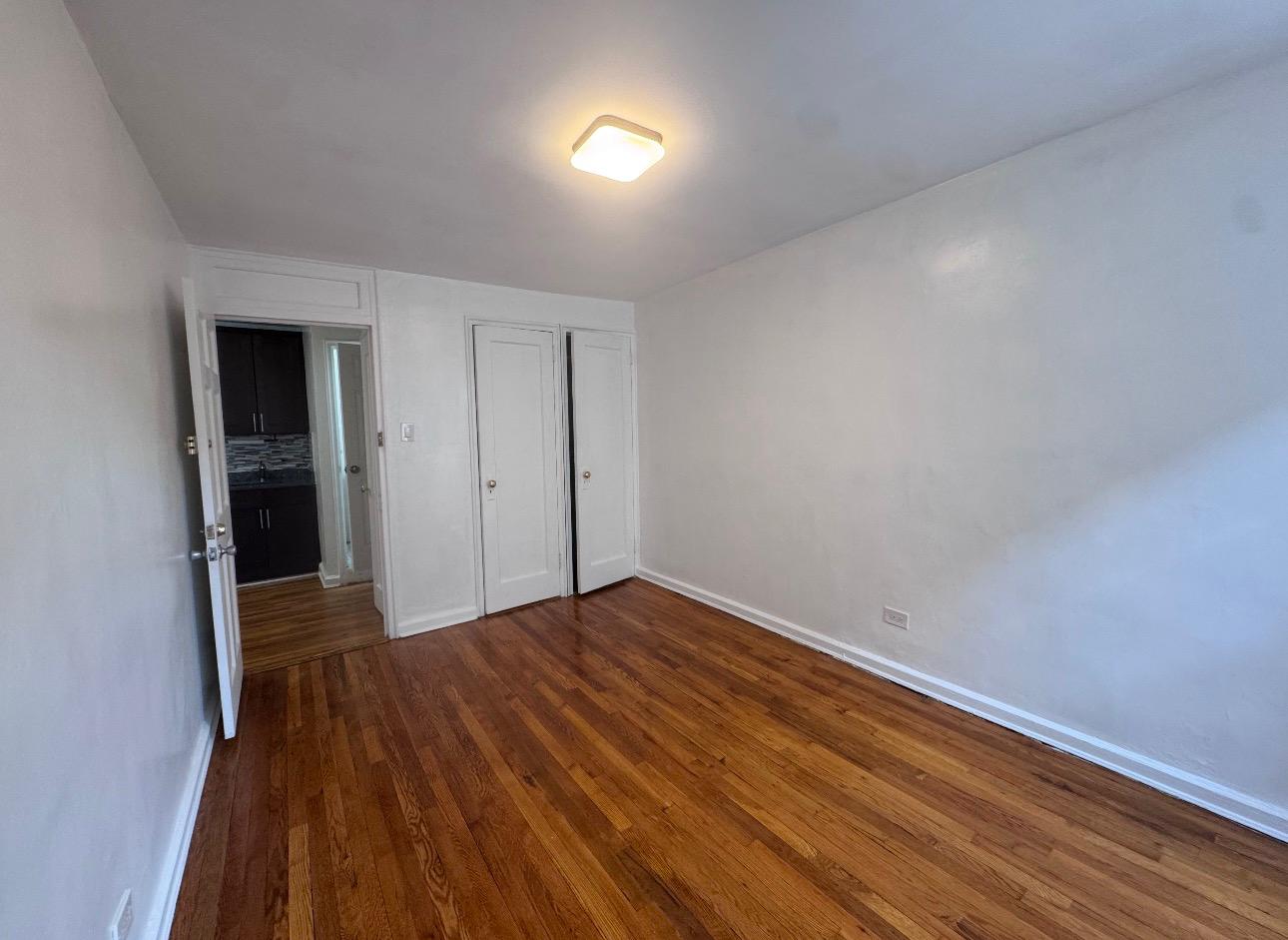 123 Avenue A, Unit 4 Manhattan, NY 10009 - Photo 8 of 14 a view of empty room with wooden floor