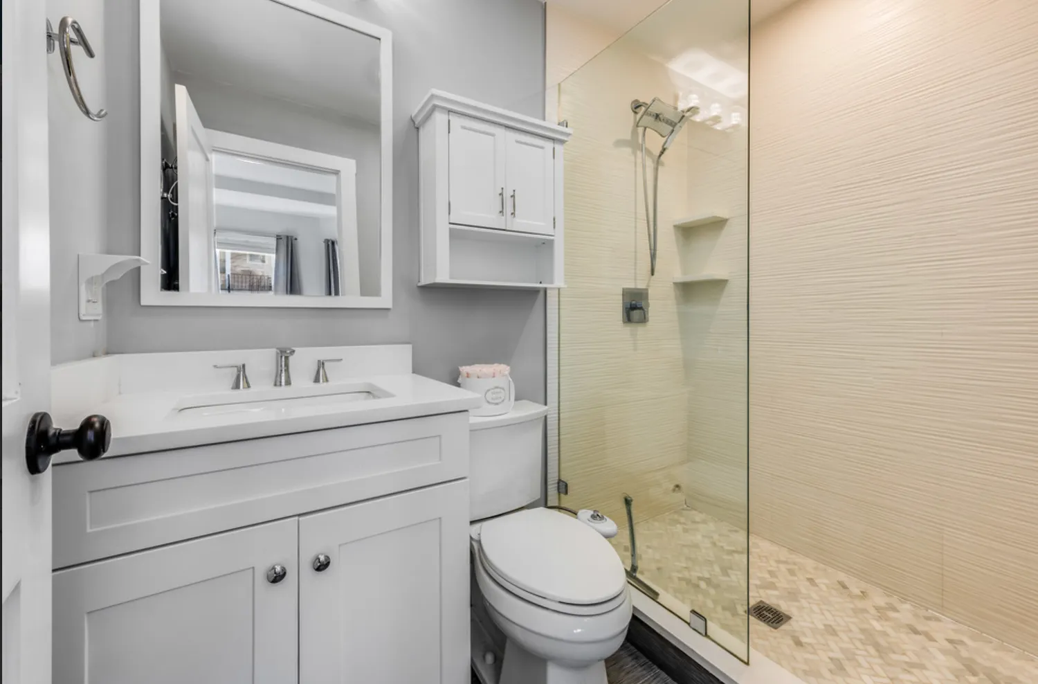 a bathroom with a sink toilet vanity and shower