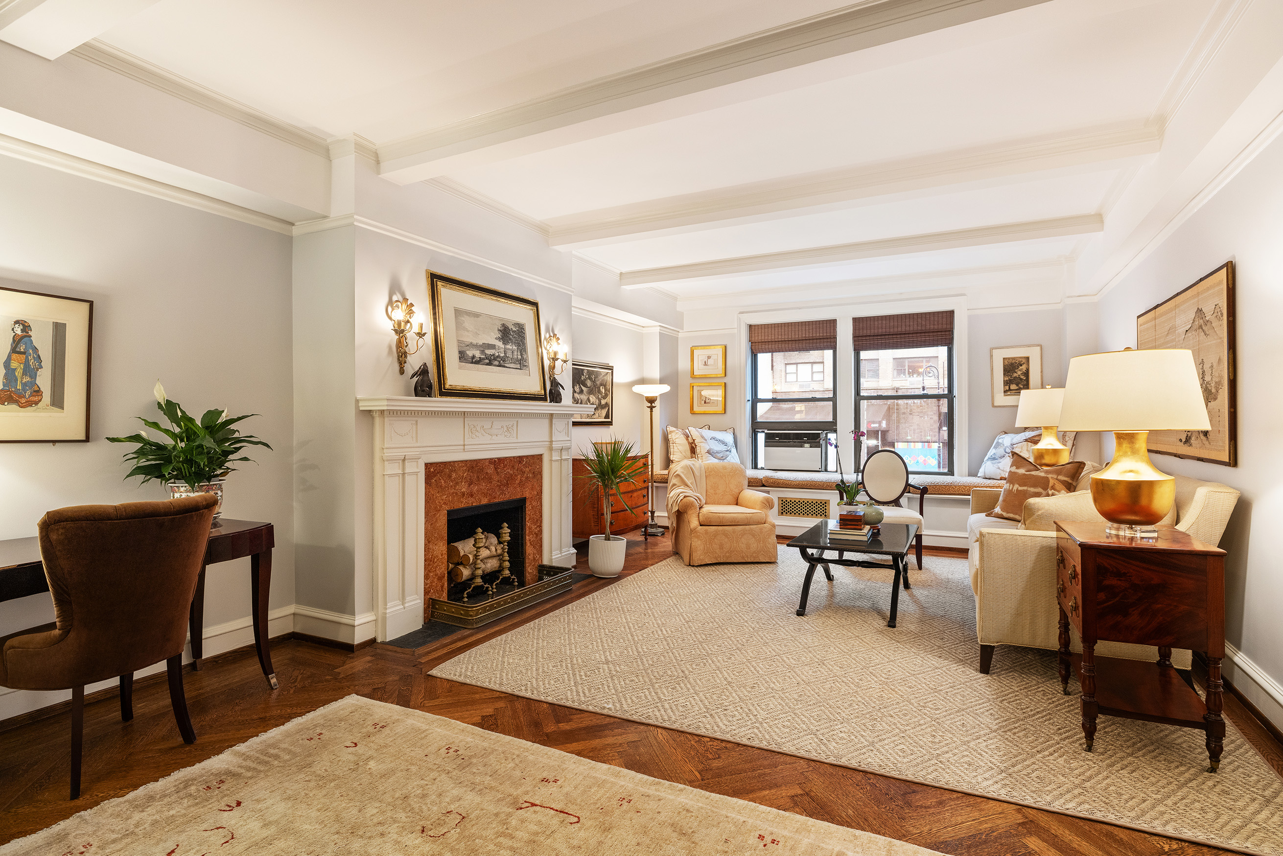 a living room with furniture lamp and a fireplace