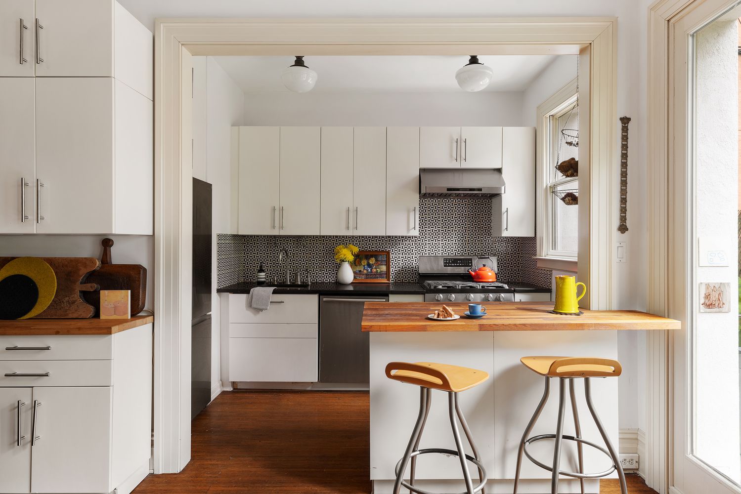 a kitchen with stainless steel appliances granite countertop a stove and white cabinets
