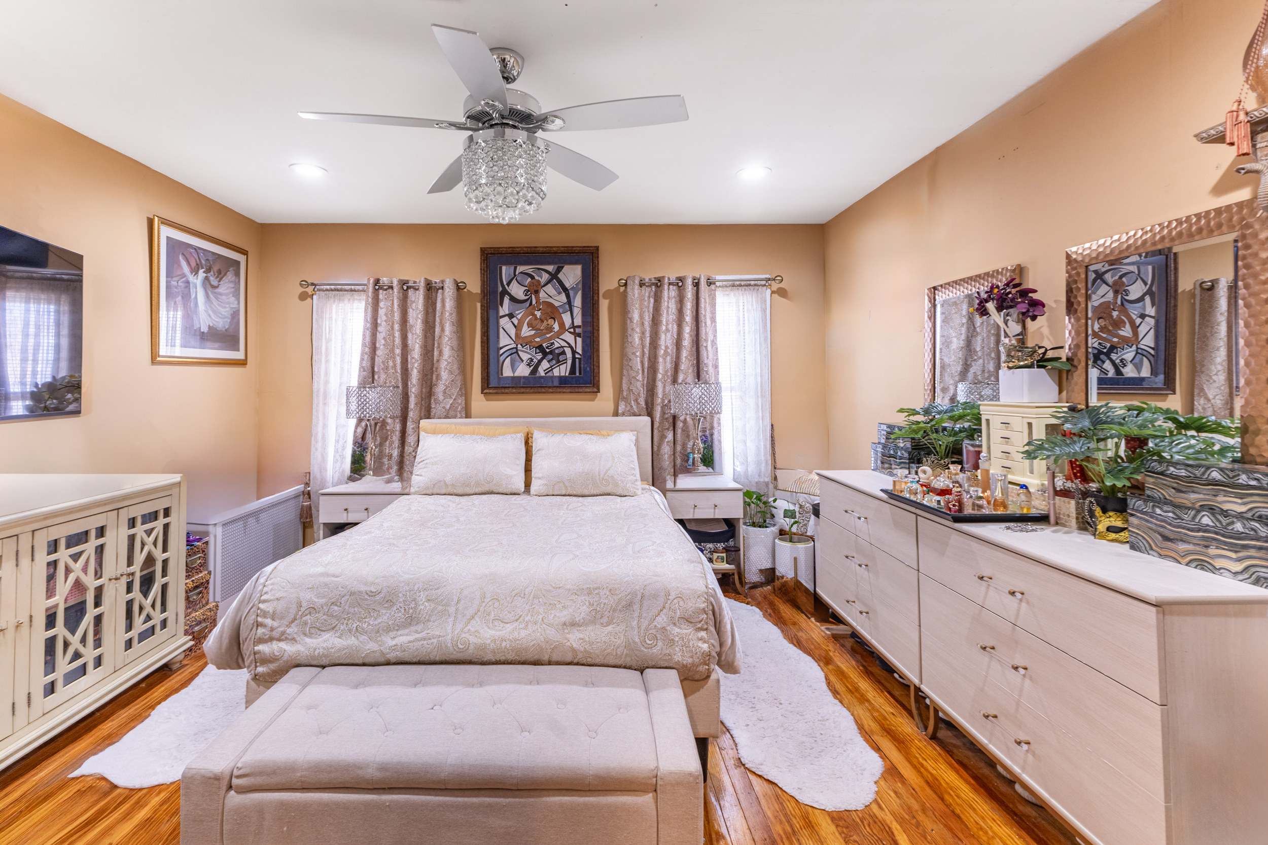 961 East 32nd Street Brooklyn, NY 11210 - Photo 7 of 24 a spacious bedroom with a large bed and a chandelier