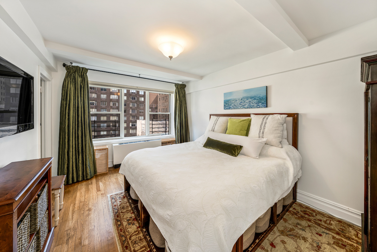 424 East 52nd Street, Unit 9B Manhattan, NY 10022 - Photo 6 of 9 a bedroom with a bed and wooden floor