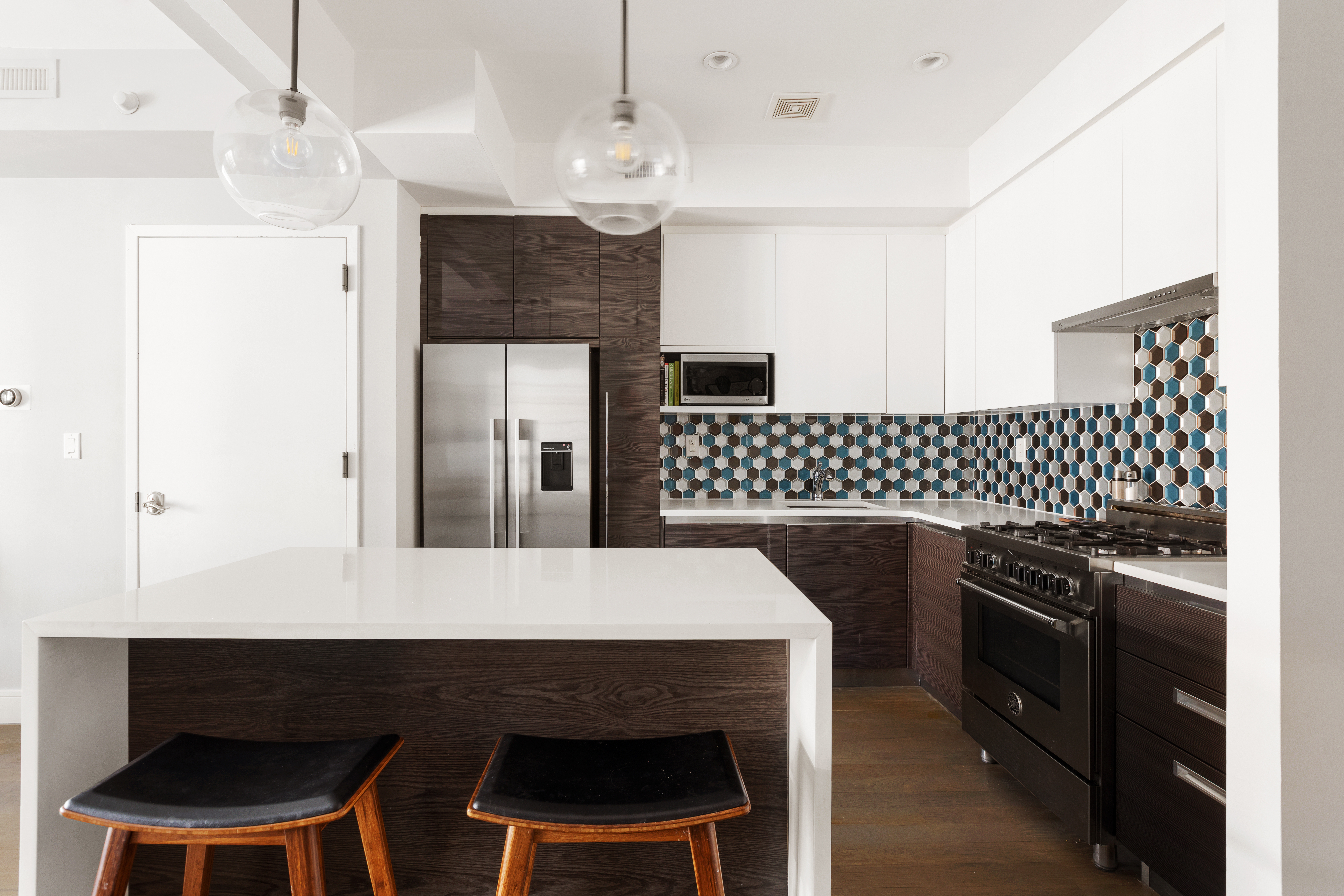 476 Hancock Street, Unit 3 Brooklyn, NY 11233 - Photo 4 of 9 a kitchen with a table chairs and a refrigerator