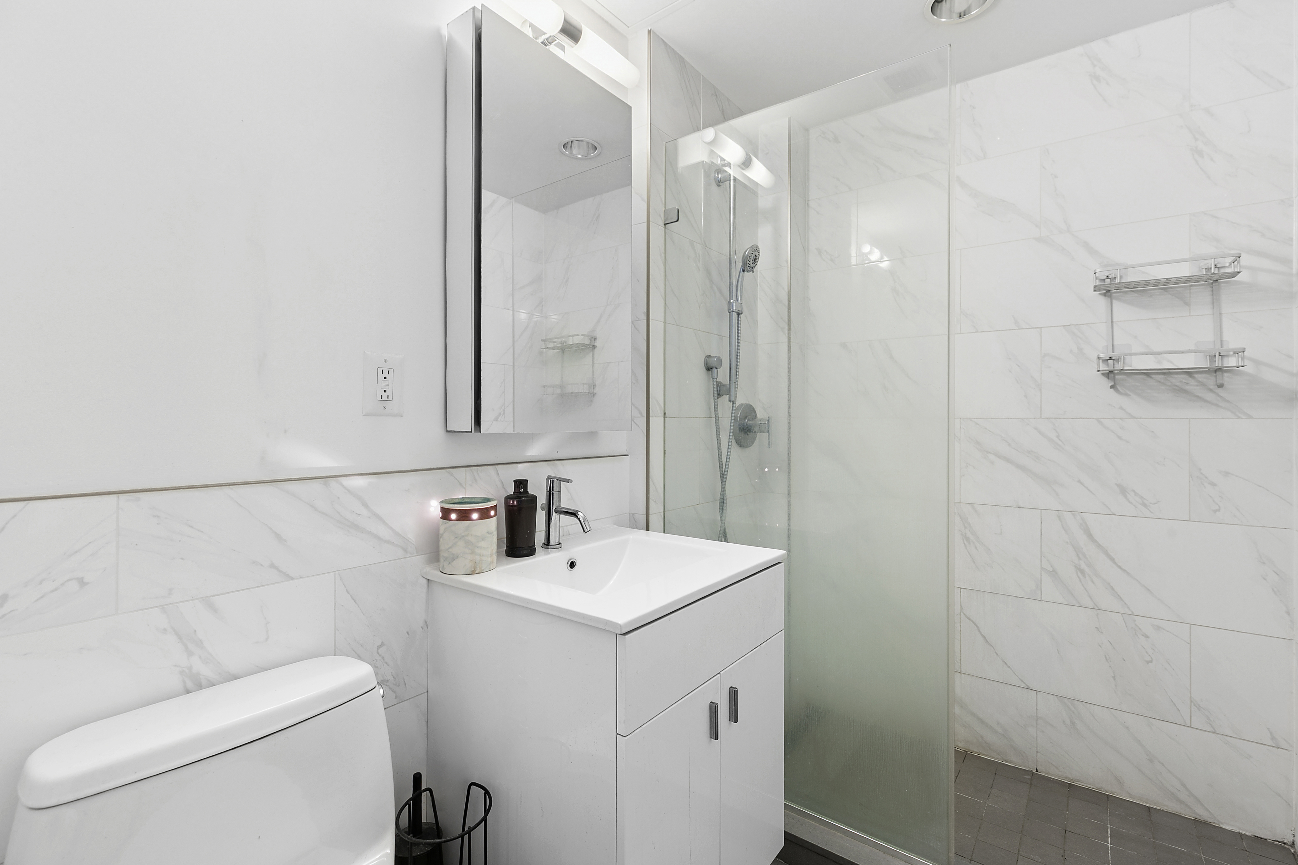 171 West 131st Street, Unit PH3 Manhattan, NY 10027 - Photo 4 of 13 a bathroom with a toilet sink and mirror