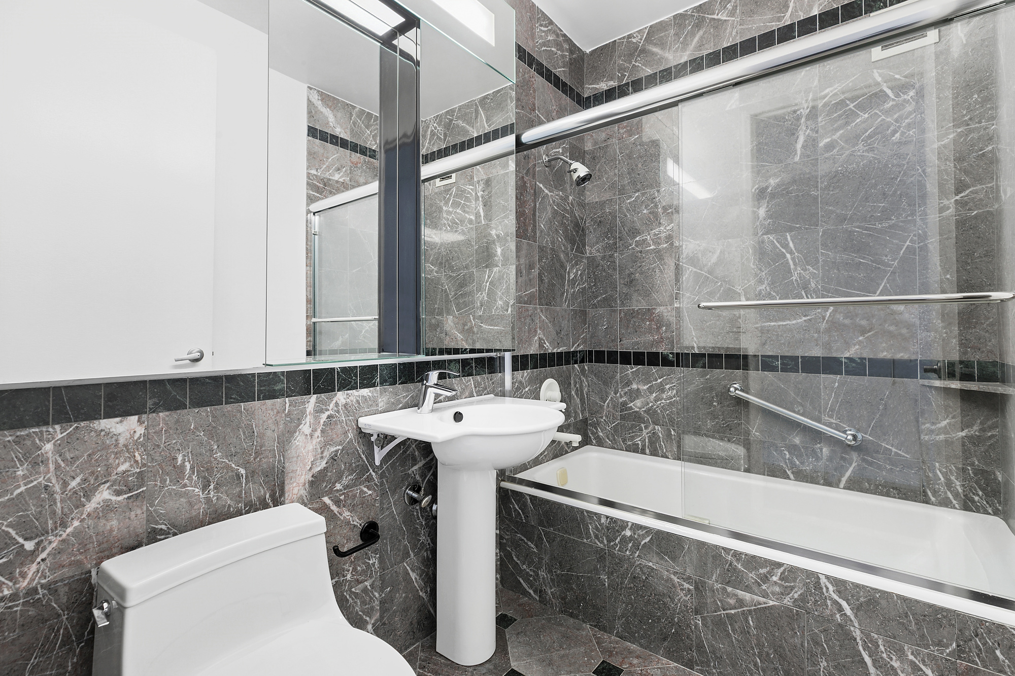 250 East 54th Street, Unit 35A Manhattan, NY 10022 - Photo 6 of 13 a bathroom with a sink a toilet and shower