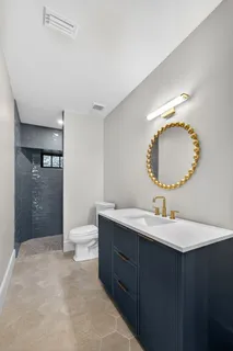 a bathroom with a toilet sink and mirror