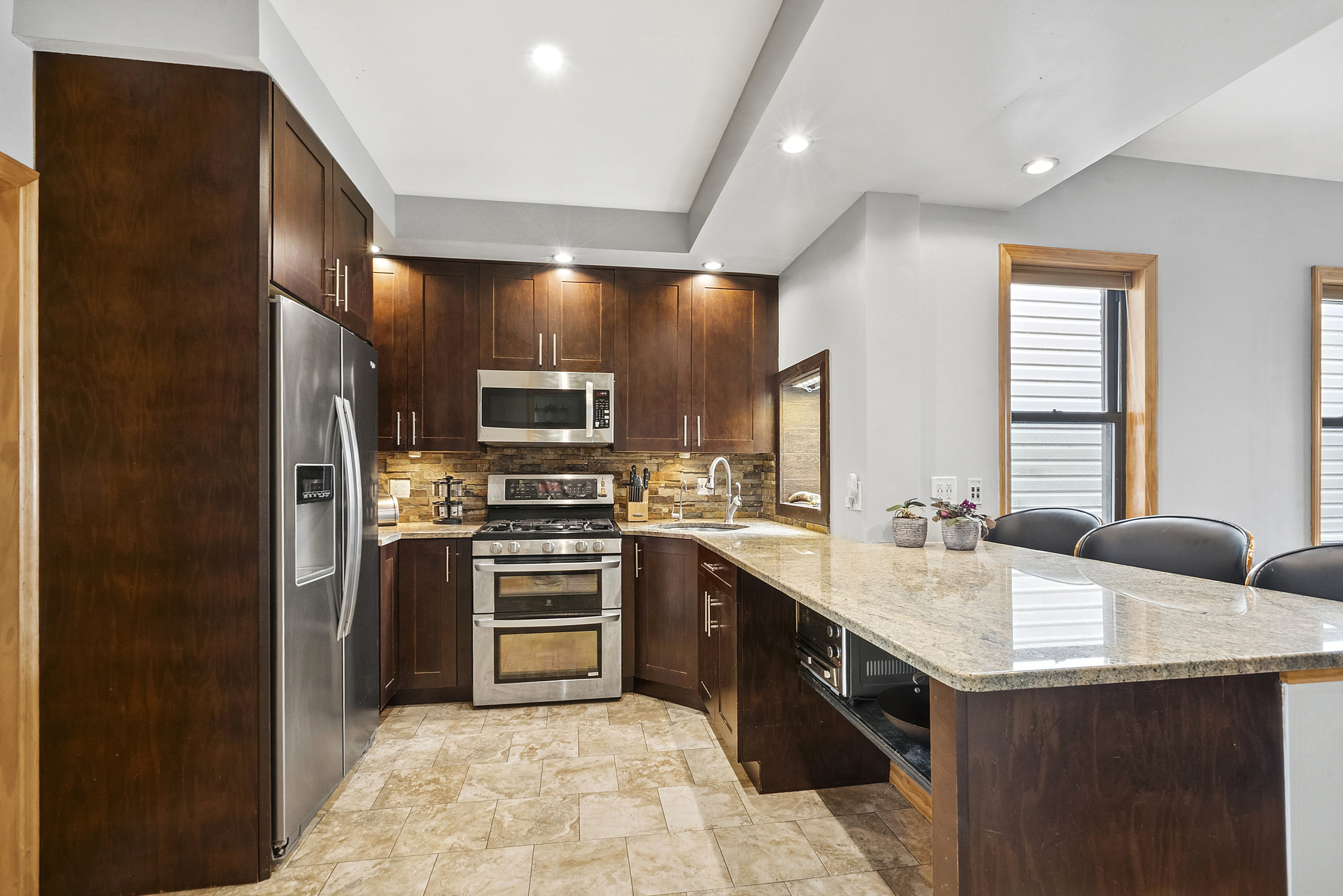 203 Battery Avenue Brooklyn, NY 11209 - Photo 2 of 14 a kitchen with a sink stove and refrigerator