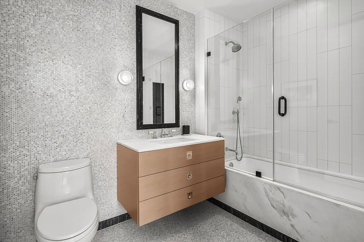 438 East 12th Street, Unit 6F Manhattan, NY 10009 - Photo 13 of 27 a bathroom with a granite countertop toilet sink and mirror