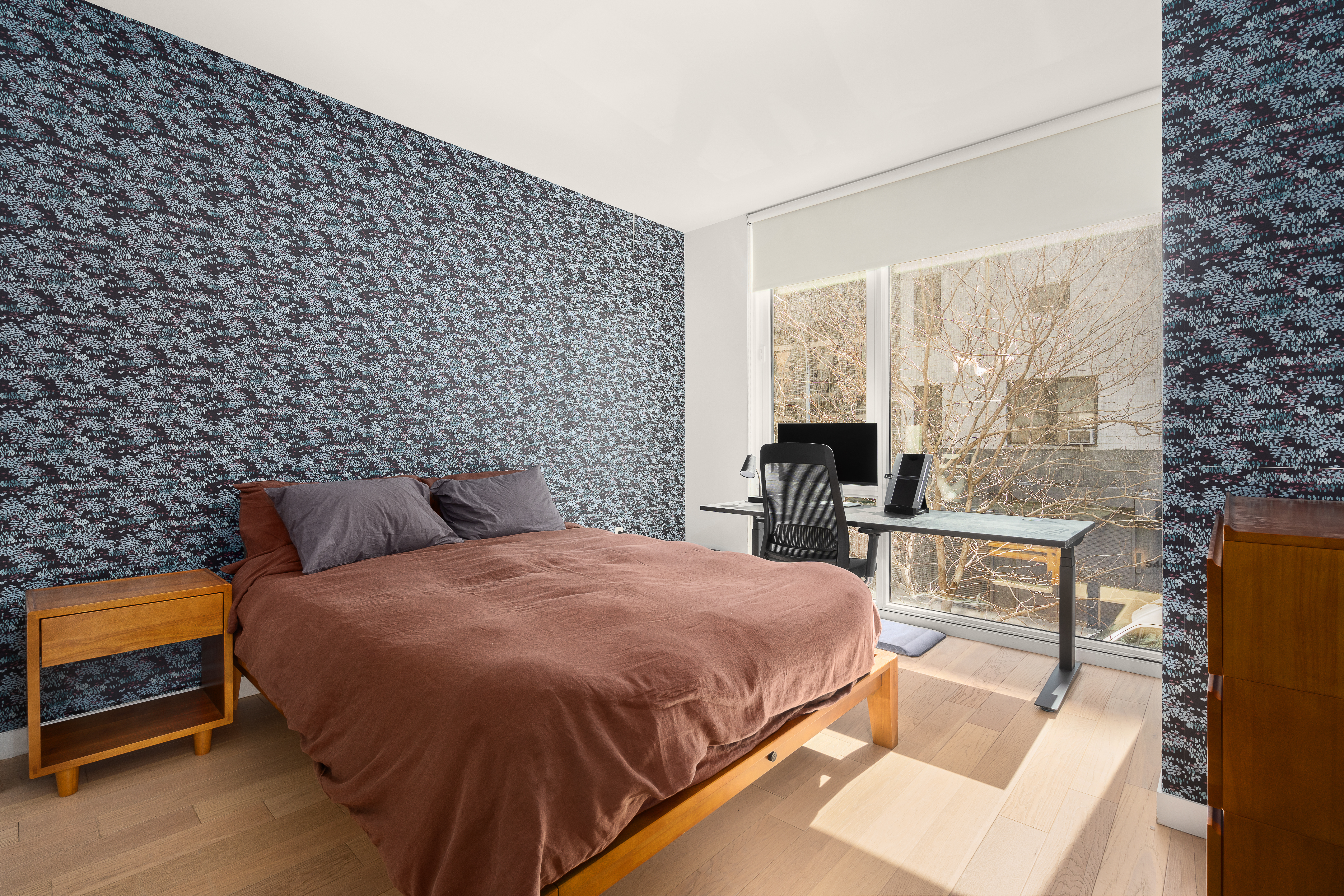 545 West 48th Street, Unit 308S Manhattan, NY 10036 - Photo 6 of 8 a bedroom with a bed a table and chair