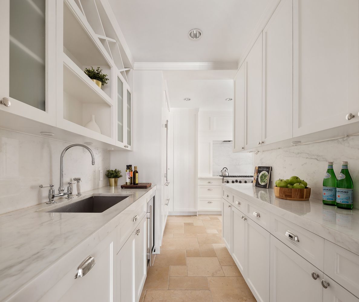 a kitchen with stainless steel appliances a sink a stove and cabinets