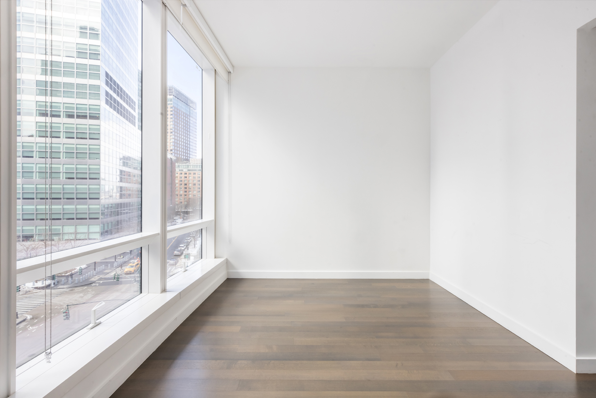 111 Murray Street, Unit 7D Manhattan, NY 10007 - Photo 15 of 17 a view of an empty room and wooden floor