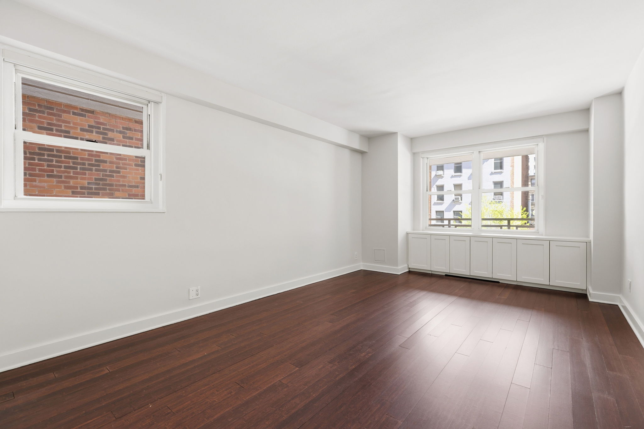 360 East 72nd Street, Unit A306 Manhattan, NY 10021 - Photo 11 of 17 a view of an empty room with wooden floor and a window