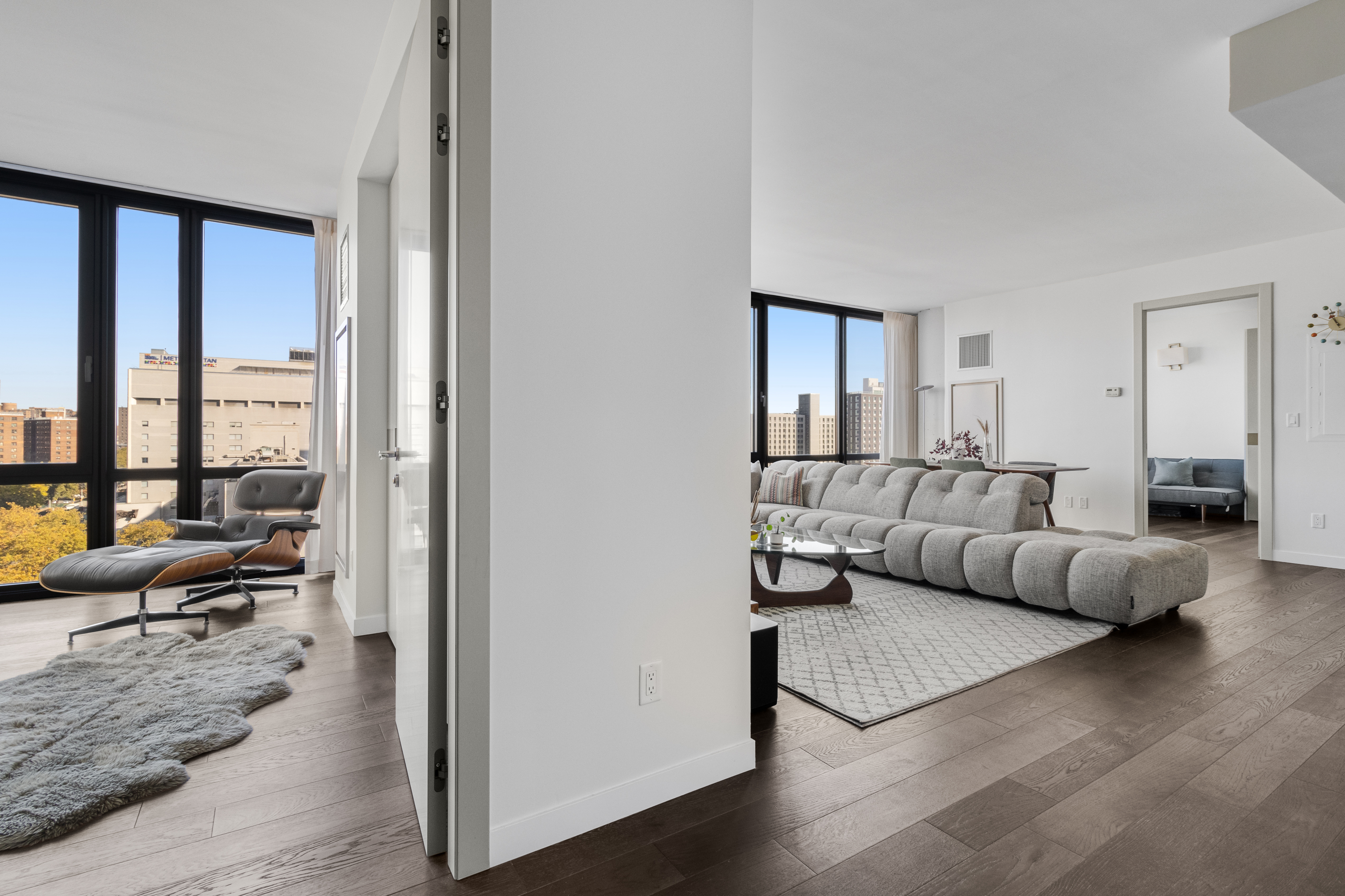 302 East 96th Street, Unit 1103 Manhattan, NY 10128 - Photo 5 of 22 a living room with furniture and a large window