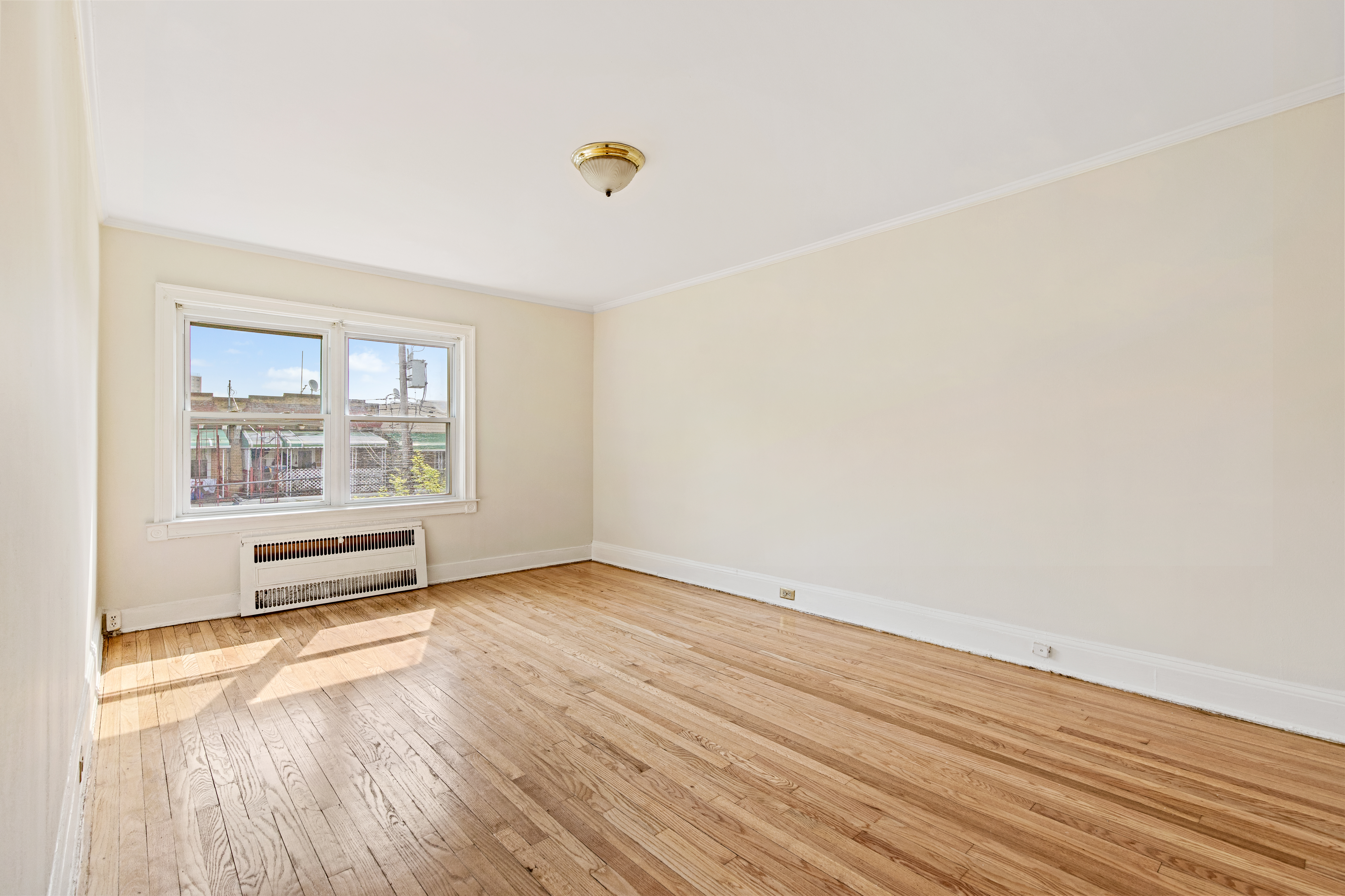 32 Tudor Terrace Brooklyn, NY 11224 - Photo 8 of 15 an empty room with wooden floor and windows