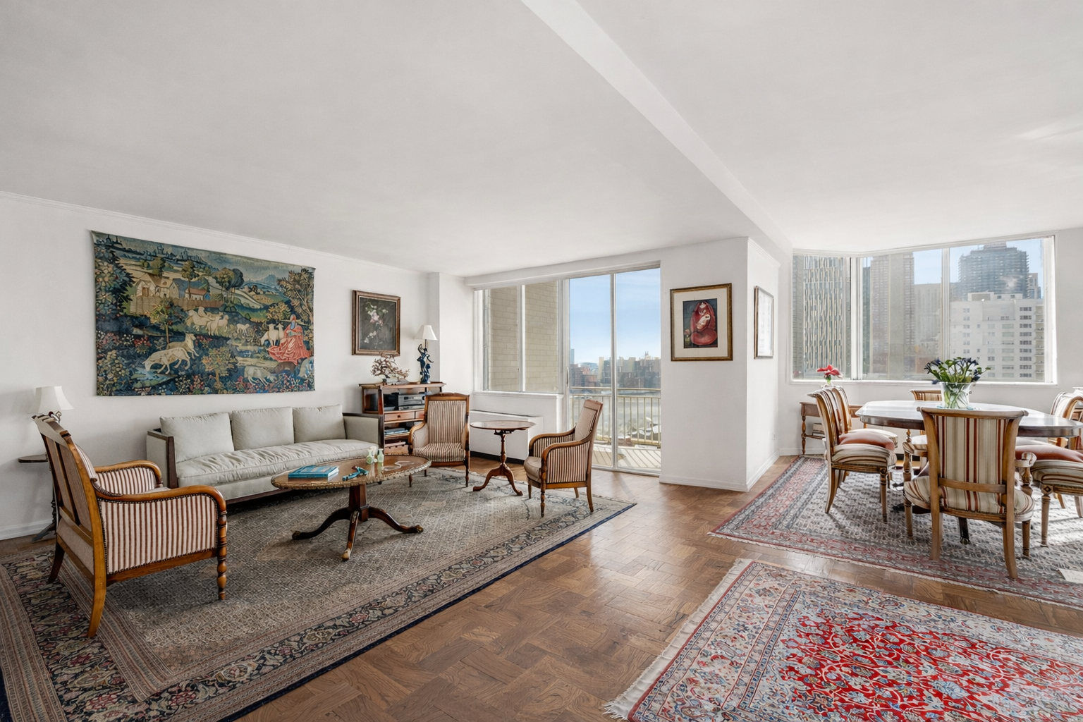 515 East 79th Street, Unit 15A Manhattan, NY 10075 - Photo 4 of 26 a living room with furniture a rug and a view of kitchen