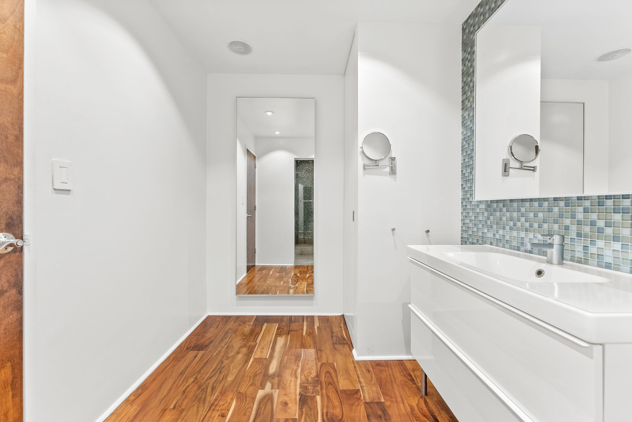 310 East 46th Street, Unit 5T Manhattan, NY 10017 - Photo 9 of 13 a bathroom with a sink and a mirror