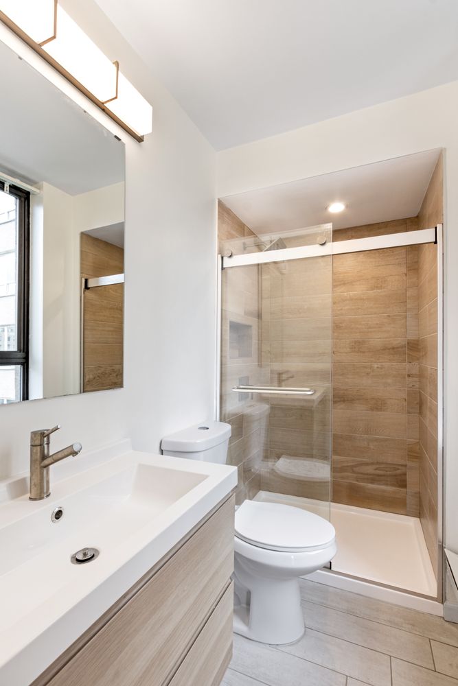 111 East 30th Street, Unit 14A Manhattan, NY 10016 - Photo 9 of 16 a bathroom with a sink a toilet and shower