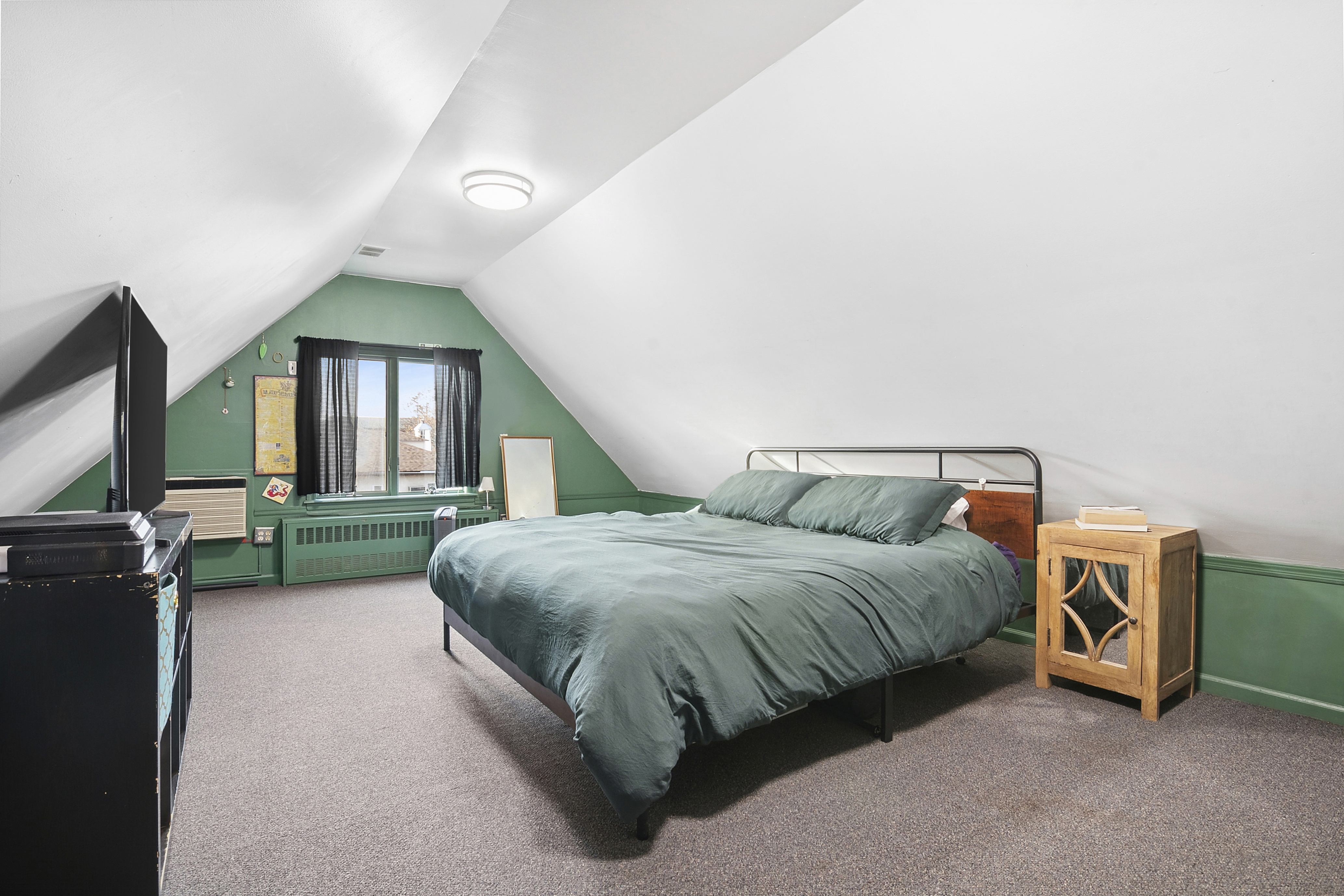 1384 East 29th Street Brooklyn, NY 11210 - Photo 11 of 21 a spacious bedroom with a bed and a window