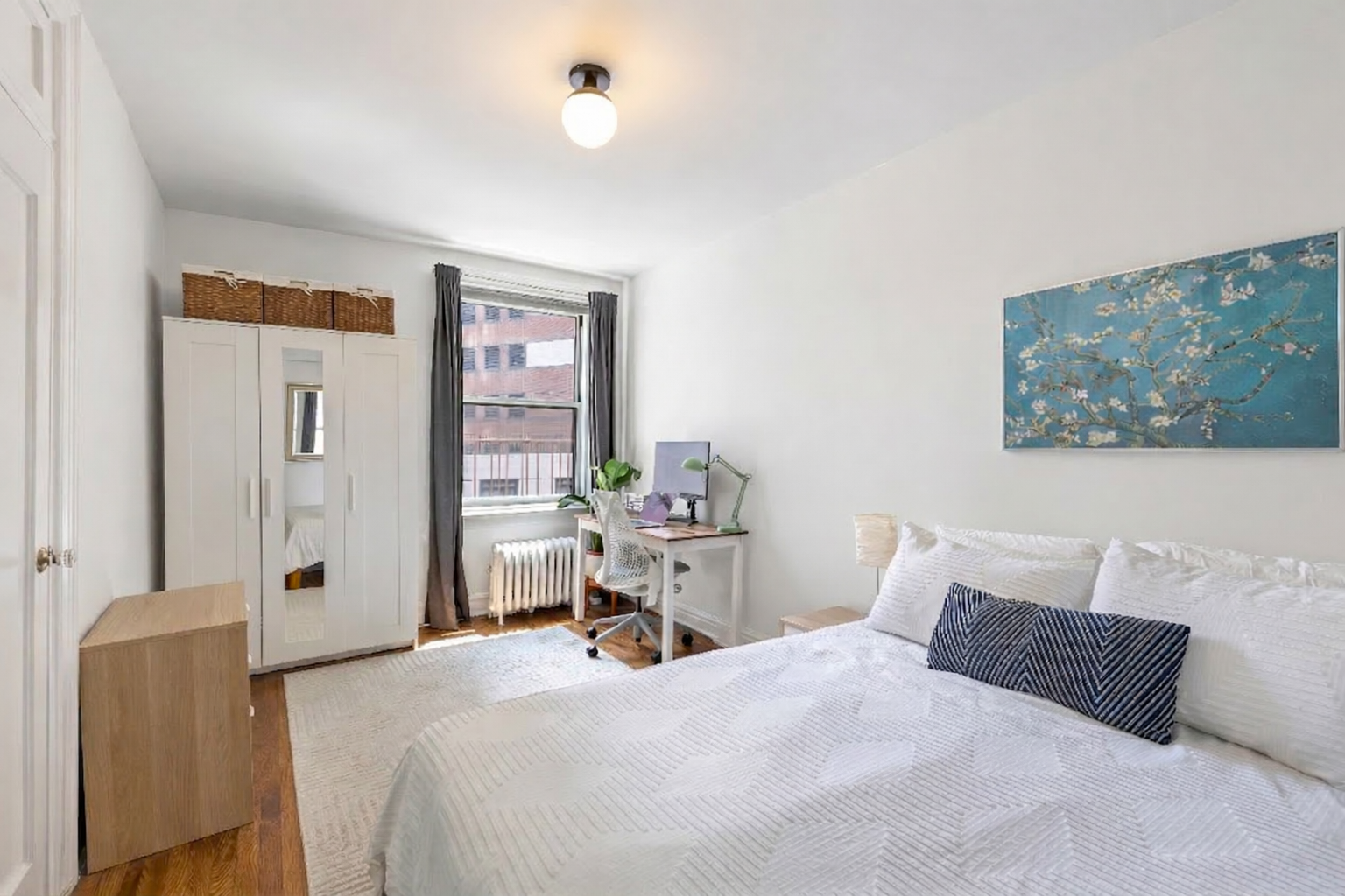 30 Clinton Street, Unit 6A Brooklyn, NY 11201 - Photo 3 of 11 a bedroom with a large bed and a chandelier