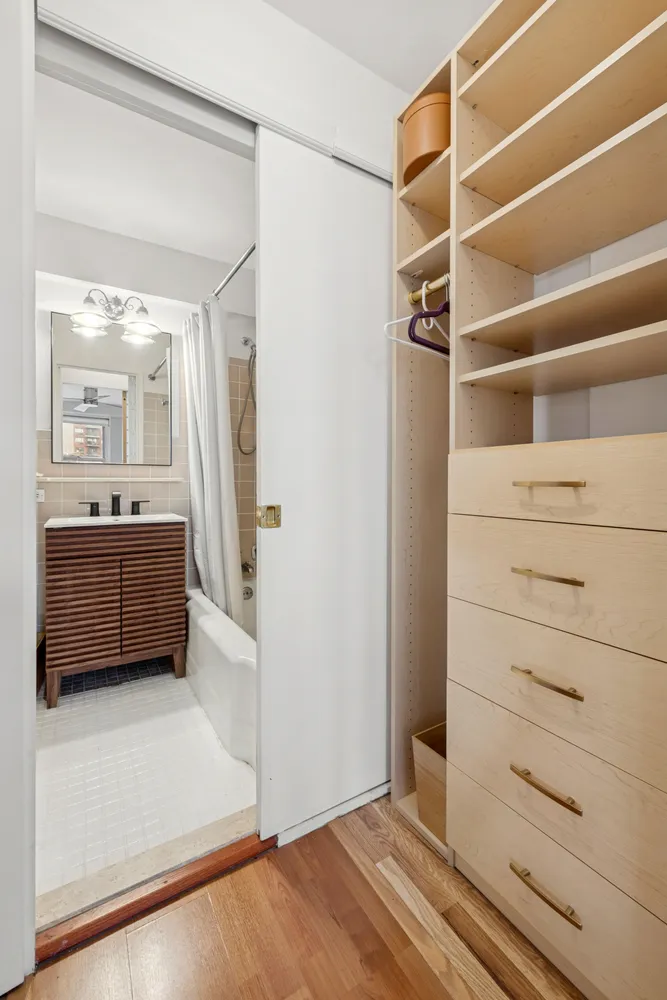 a view of walk in closet with empty racks