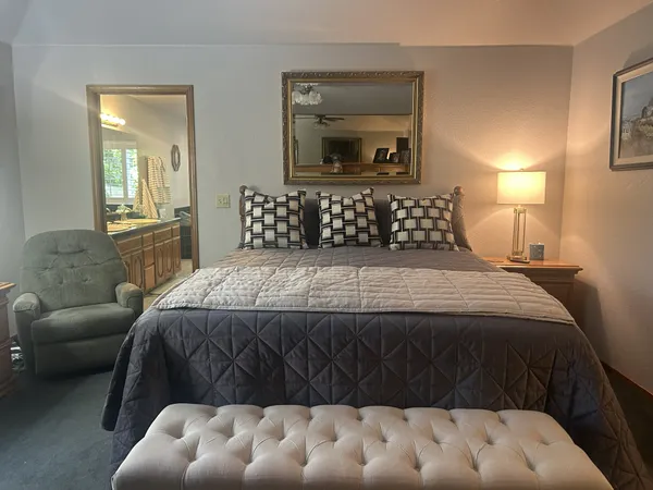 a bedroom with a bed and a couch