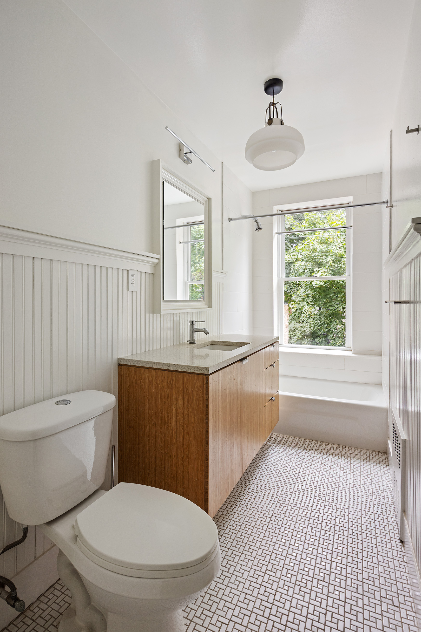 64 Clifton Place, Unit 2 Brooklyn, NY 11238 - Photo 11 of 16 a bathroom with a granite countertop toilet a sink and a bathtub