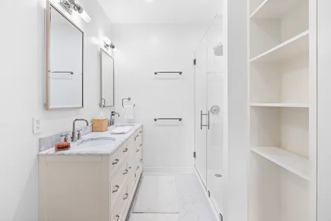 a bathroom with a double vanity sink and mirror