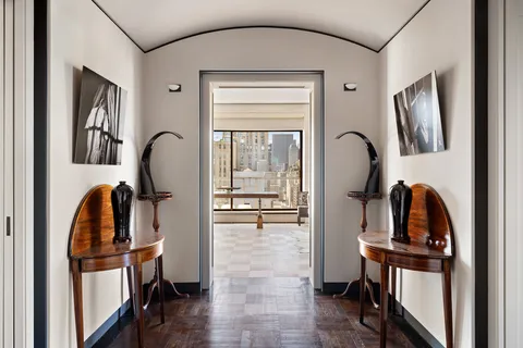 a view of living room with furniture and wooden floor