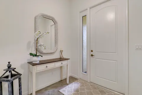 a room with a mirror and cabinets
