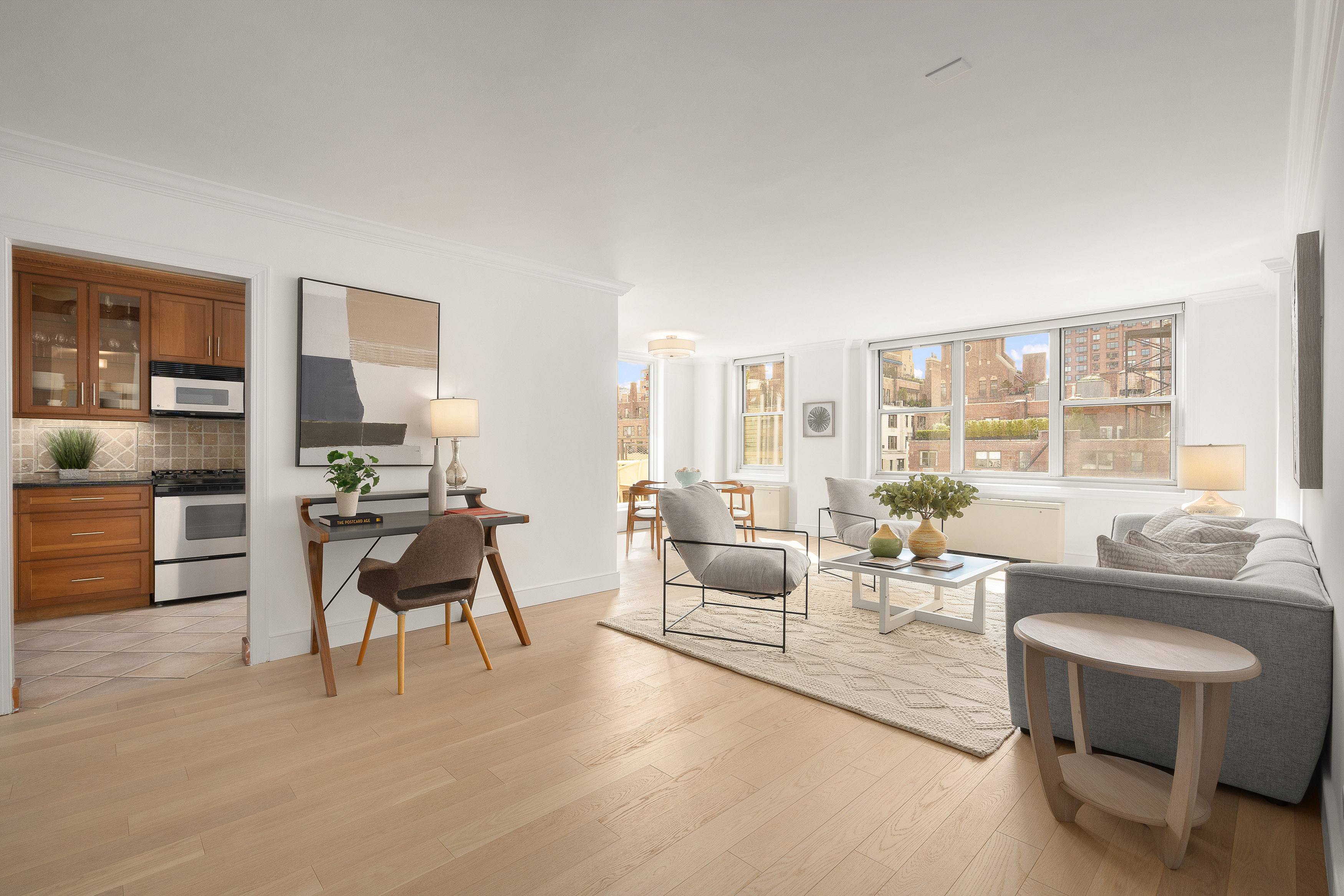 207 East 74th Street, Unit 11E Manhattan, NY 10021 - Photo 1 of 20 a living room with furniture and a large window