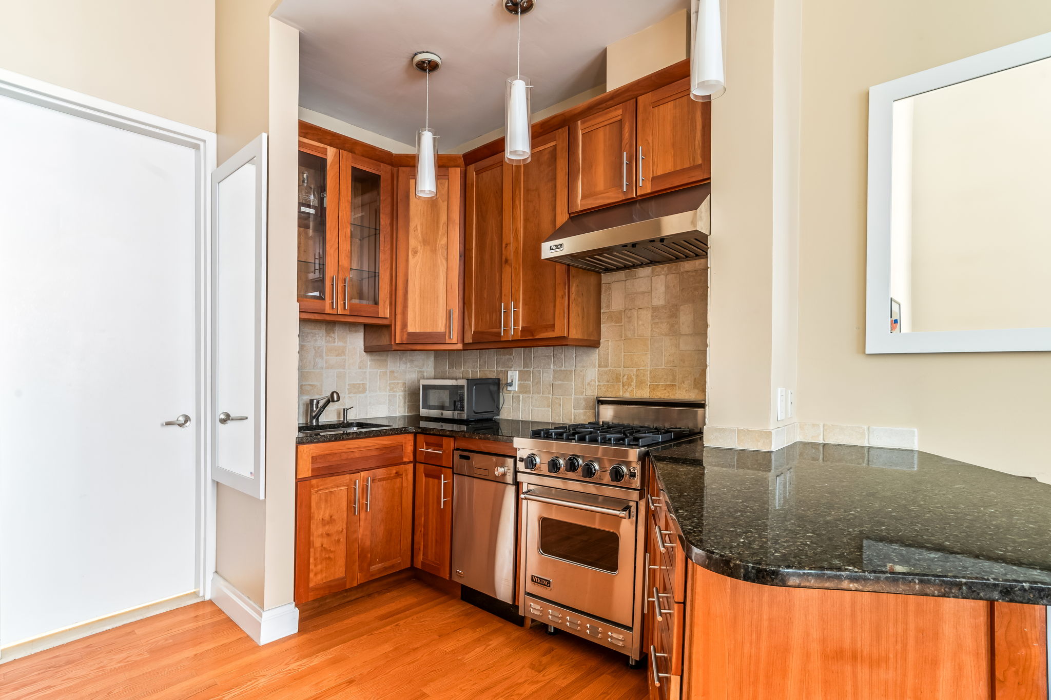 120 East 87th Street, Unit R6L Manhattan, NY 10028 - Photo 6 of 19 a kitchen with stainless steel appliances granite countertop a stove a sink and a refrigerator