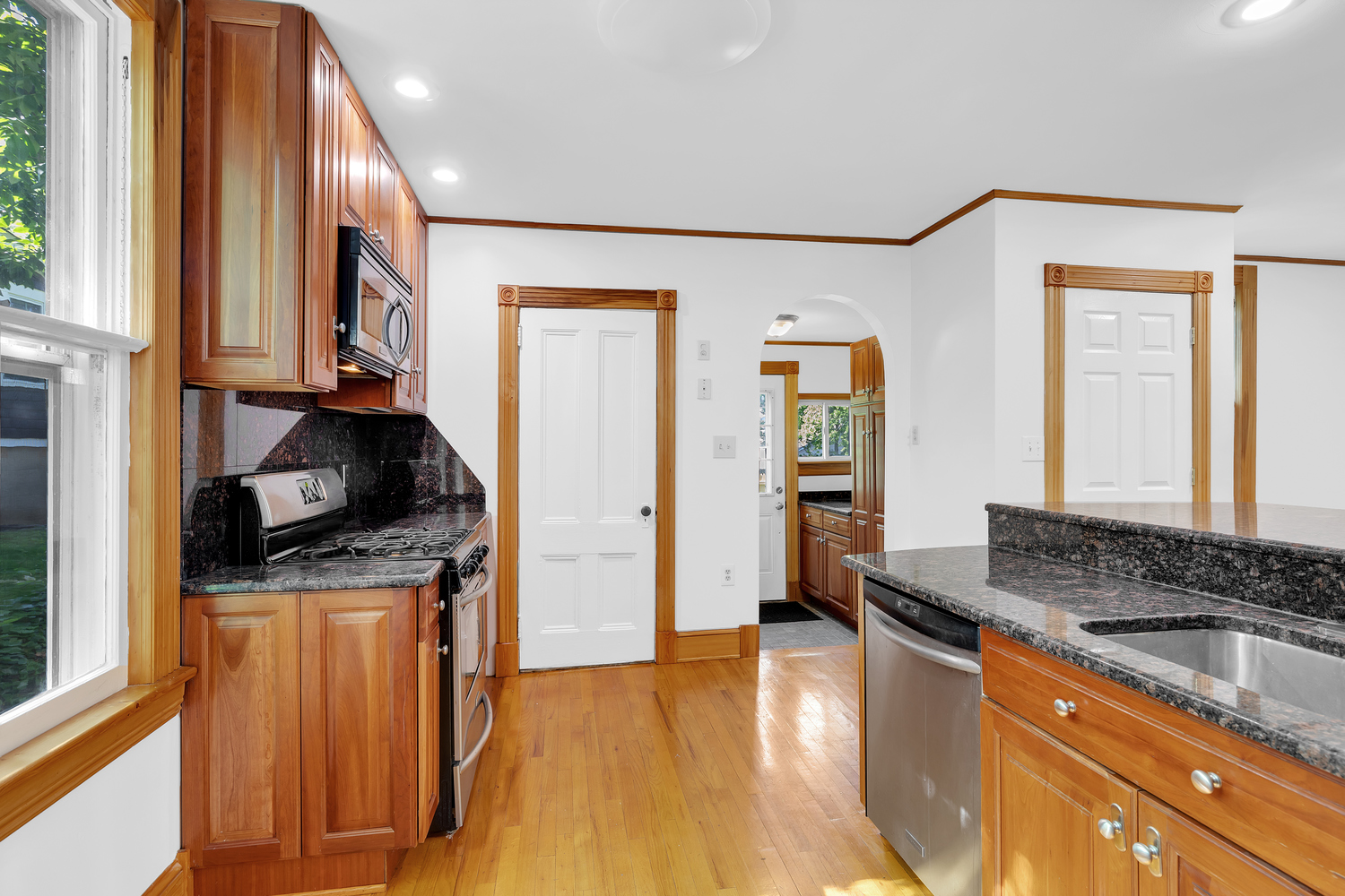 242-09 Pine Street Queens, NY 11363 - Photo 3 of 21 a kitchen with granite countertop a stove and a refrigerator