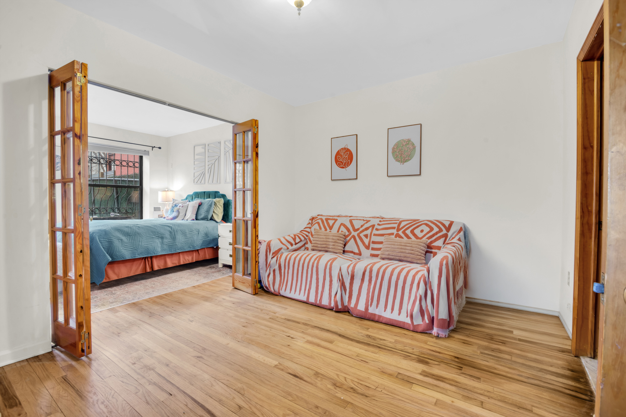 137 West 126th Street, Unit 1 Manhattan, NY 10027 - Photo 5 of 12 a bedroom with a bed and a couch