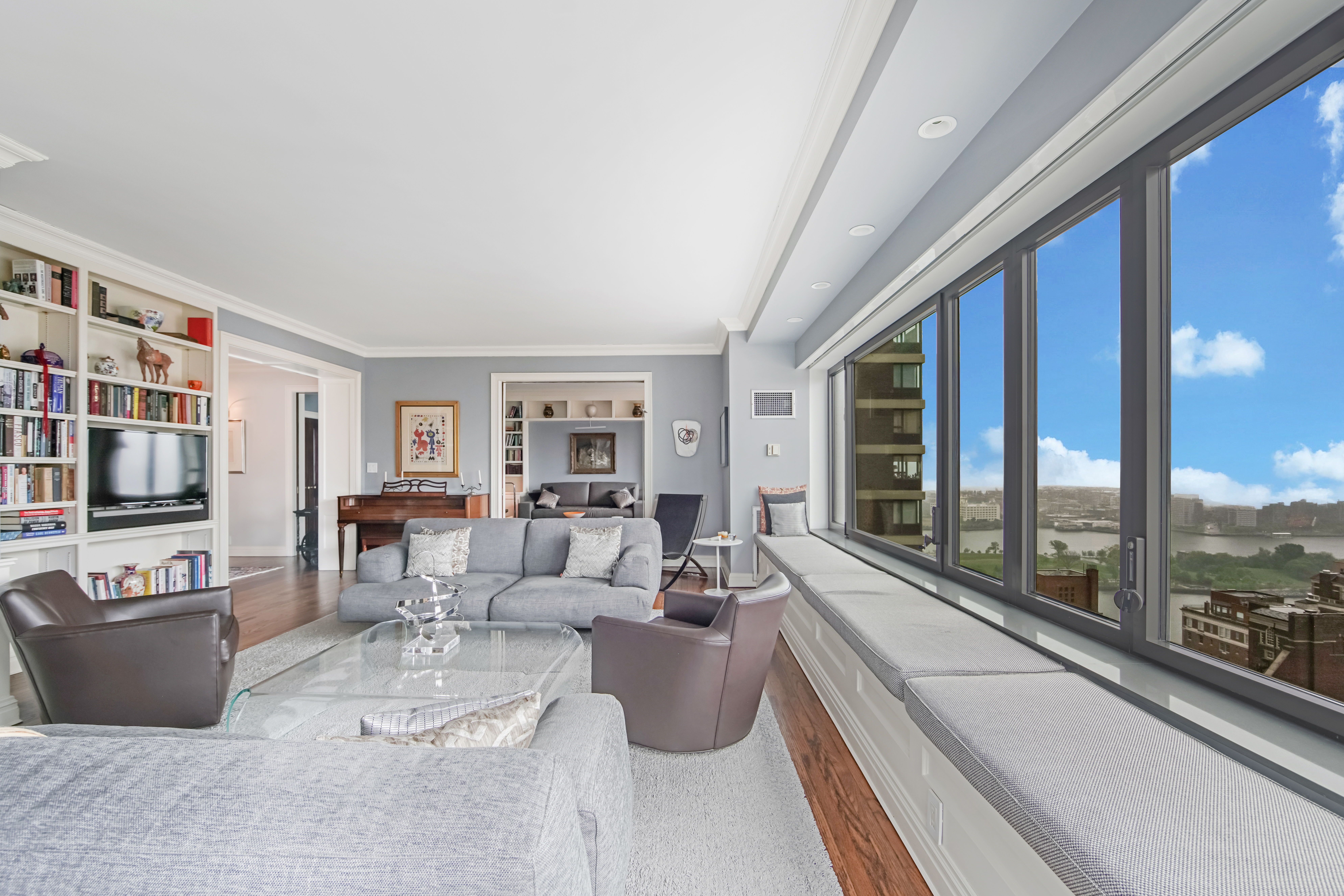 425 East 58th Street, Unit 29C Manhattan, NY 10022 - Photo 4 of 9 a living room with furniture and a floor to ceiling window