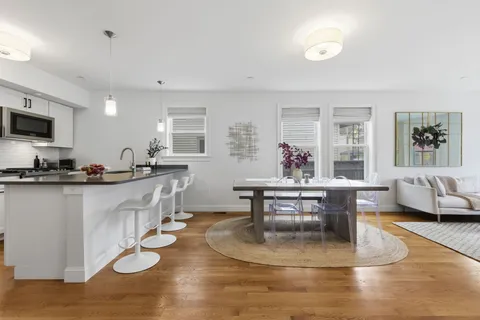 a living room with kitchen island furniture and a wooden floor