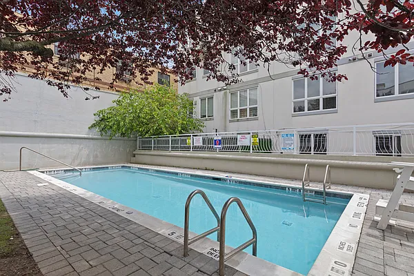 3144 Emmons Avenue, Unit 102 Brooklyn, NY 11235 - Photo 9 of 12 a view of a swimming pool with a lounge chairs