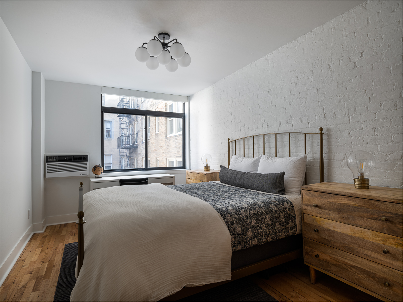 23 East 10th Street, Unit 404 Manhattan, NY 10003 - Photo 8 of 11 a bedroom with a large bed and a window