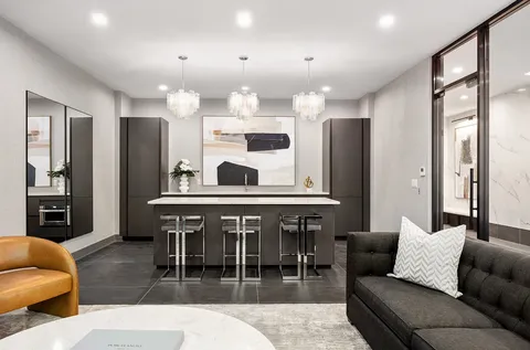 a living room with furniture kitchen view and a large window