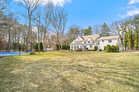 a view of a white house with a swimming pool