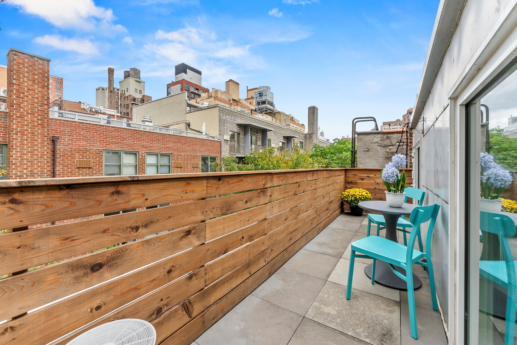 207 East 21st Street, Unit 6E Manhattan, NY 10010 - Photo 6 of 12 a view of a patio with a table and chairs