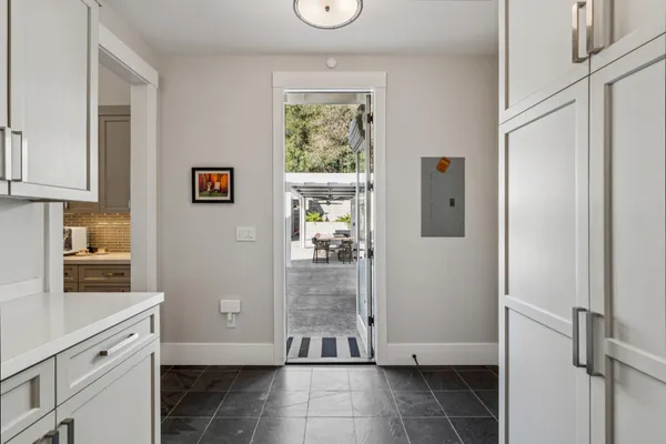 a kitchen with granite countertop white cabinets and stainless steel appliances