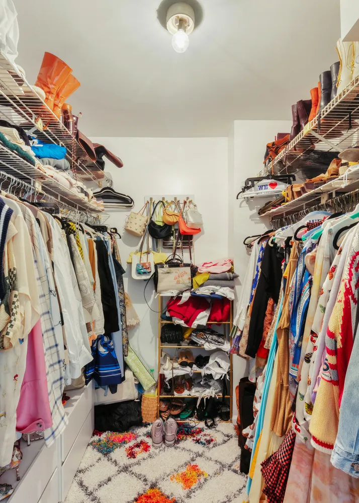 a view of walk in closet with clothes and shoes