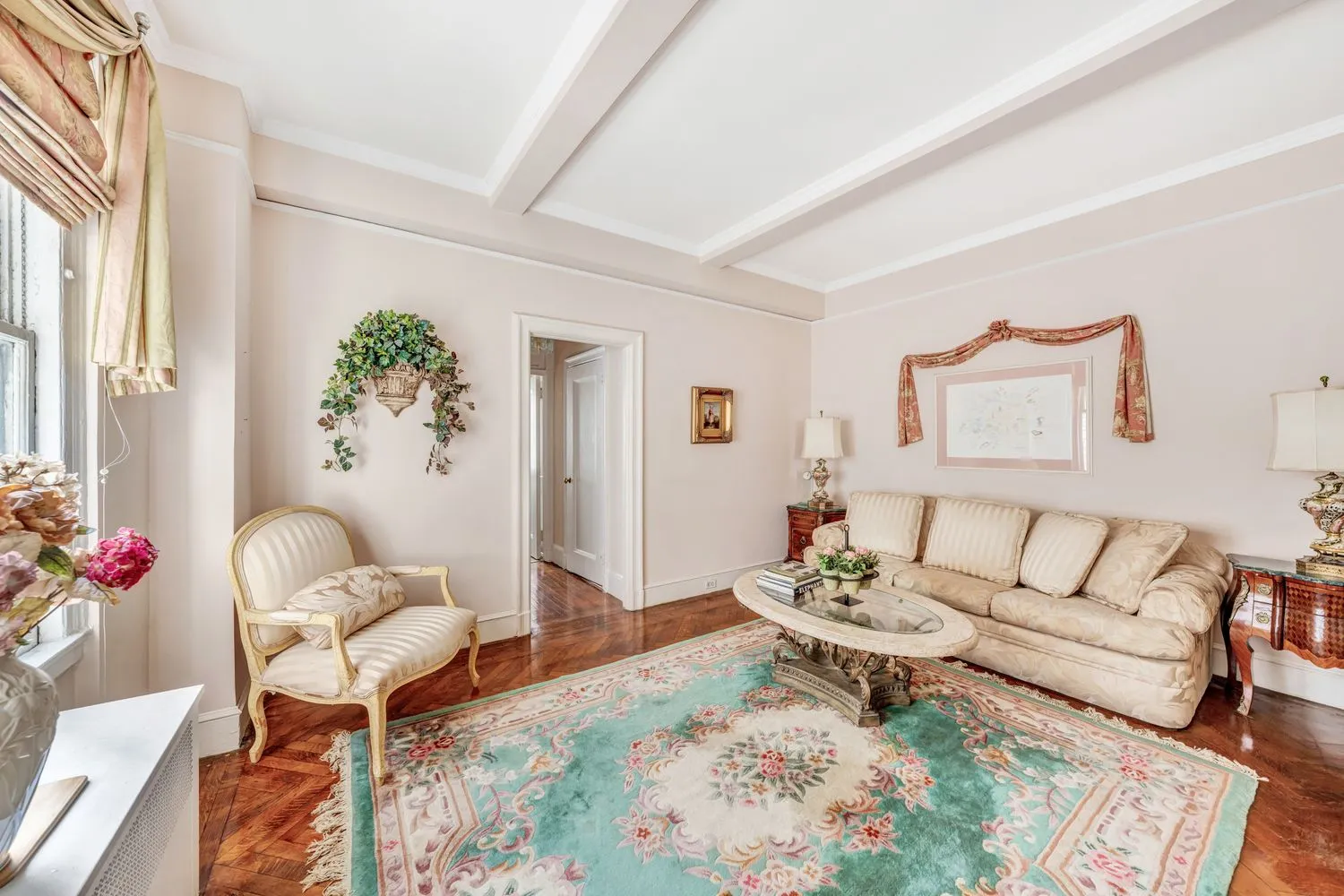 a living room with furniture and flowers