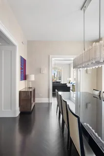 a dining room with furniture and wooden floor