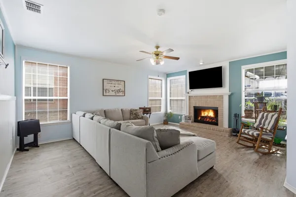 a living room with furniture and a fireplace